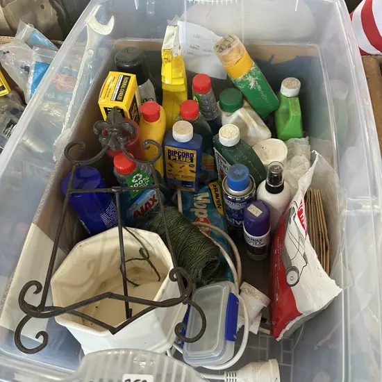 Plastic bin with wrought iron tabletop easel, cleaning products, weed killer, vacuum bags and planter etc.