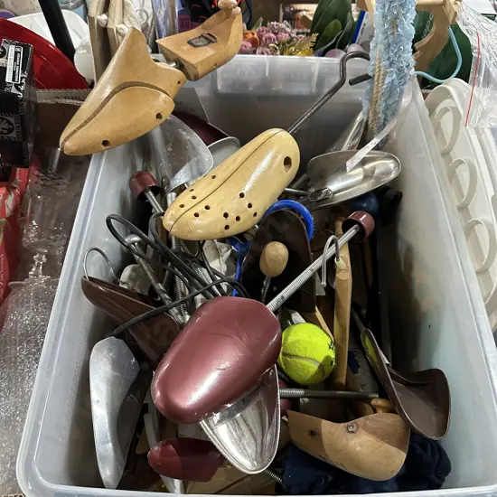 Bin full of coat hangers and shoe stretchers etc.