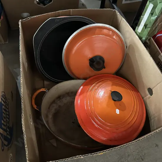 Box lot cast iron lidded casserole dishes.