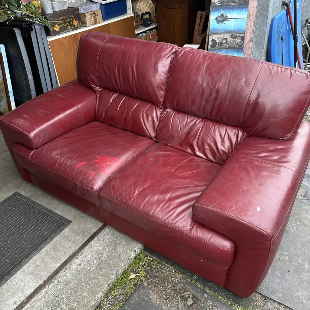 Burgandy leather sofa - has a patch on cushion Image 1++