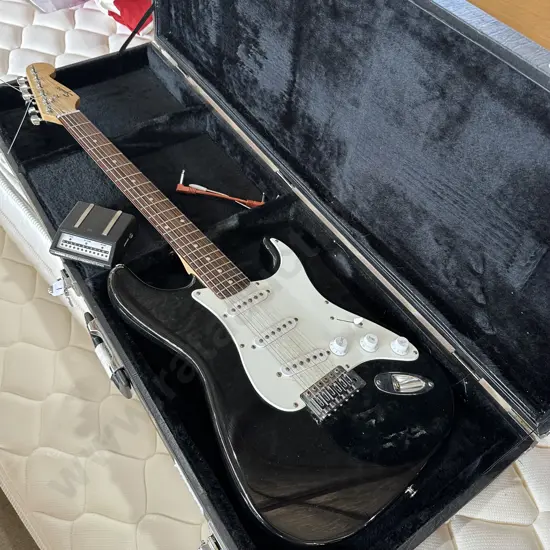 cased electric guitar by Fender
