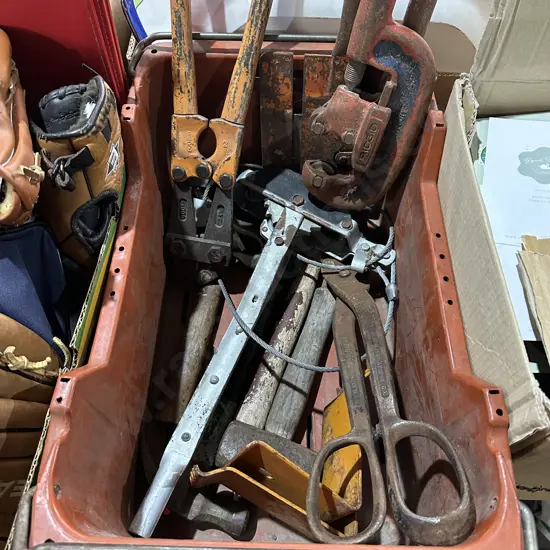 Bin of old tools including hand winch and pipe cutters etc.