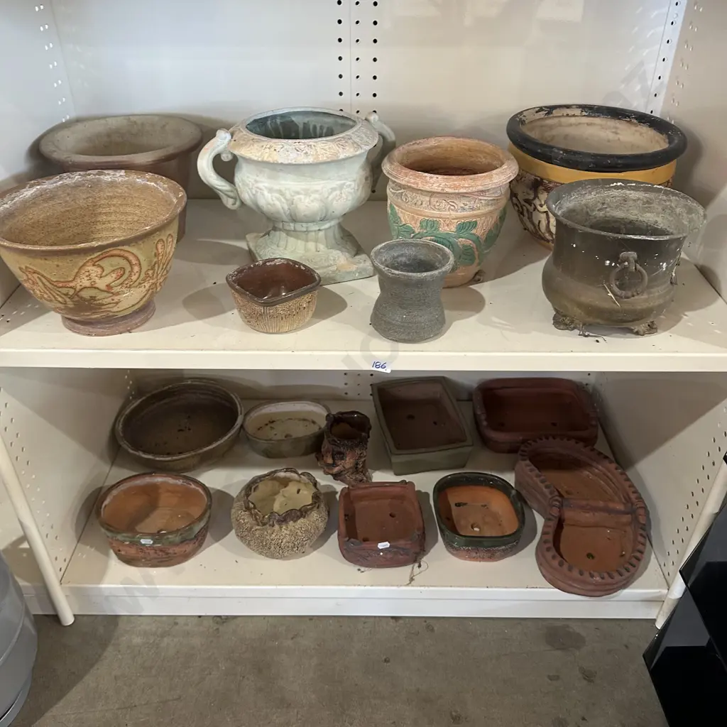 Two shelf lots of pottery planters. Image 1++