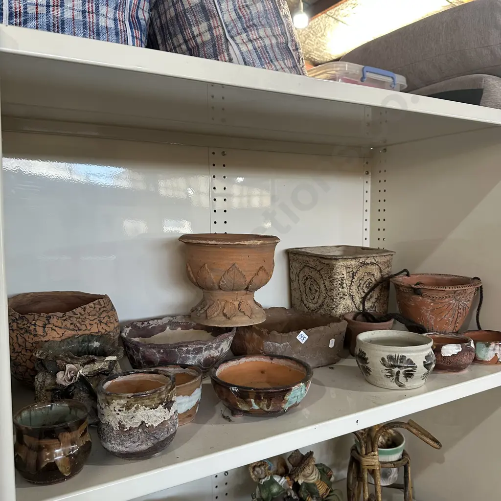 Shelf lot of pottery planters. Image 1++