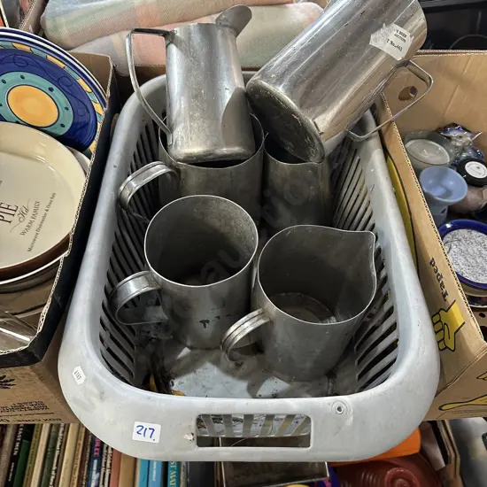 Basket of stainless steel jugs.