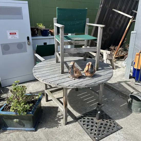 Outdoor table and two chairs plus umbrella stand.
