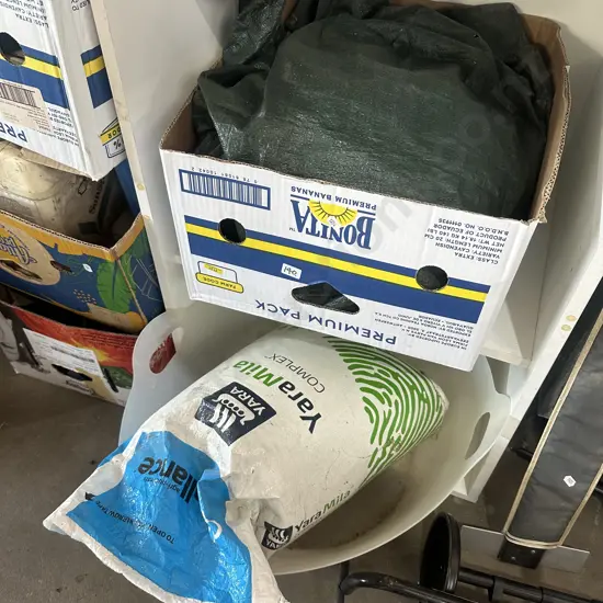 Tarp and fertilizer plus dog wash bucket.
