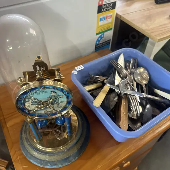 Bin of selected cutlery and clock.
