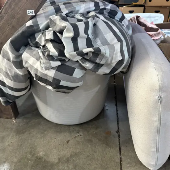 bin of bedding and cushion
