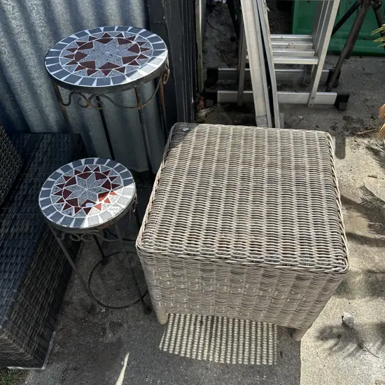 Two plant stands and wicker side table.