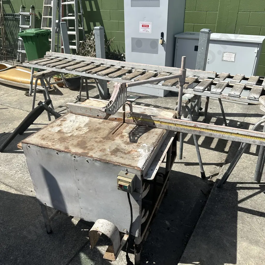 Foot operated cross cut saw with extension tables. Image 1++