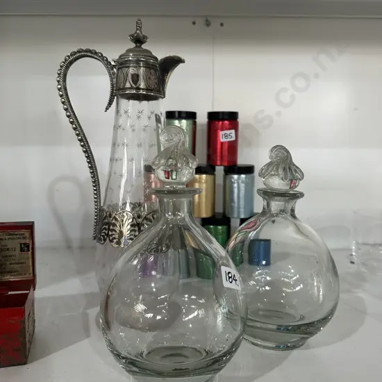 Silver plated wine pitcher plus two decanters.
