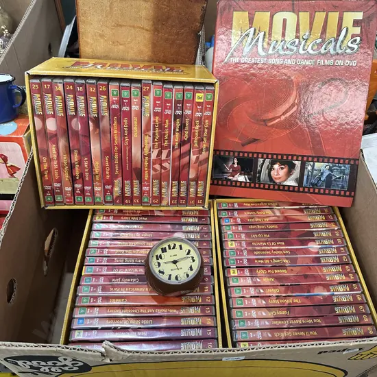 Box of movie musicals and alarm clock.