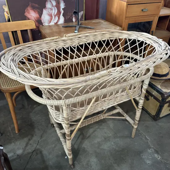 Cane bassinet with matching stand.