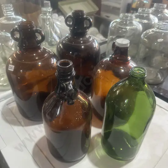 Five glass jugs.