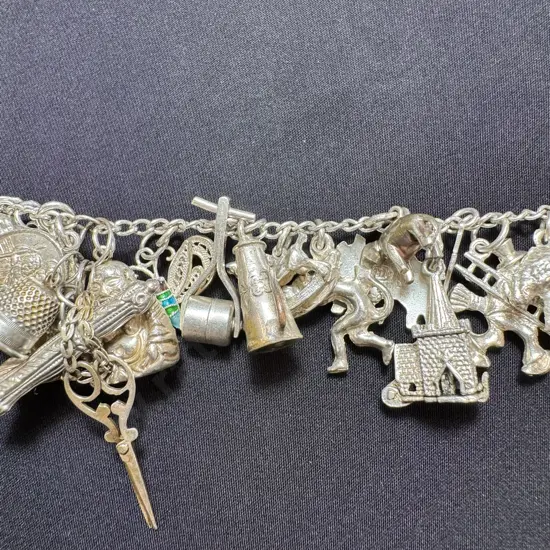 Silver charm bracelet with 31 lightweight charms