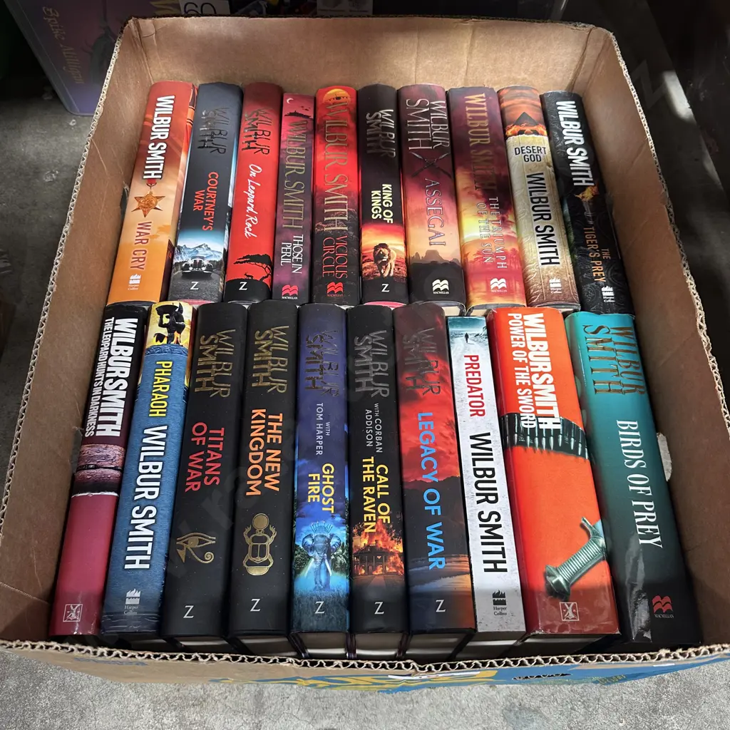 Box of Wilbur Smith books Image 1++