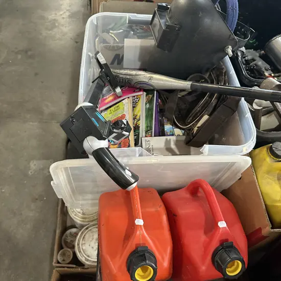 Bin of books, petrol cans, welding helmet etc.