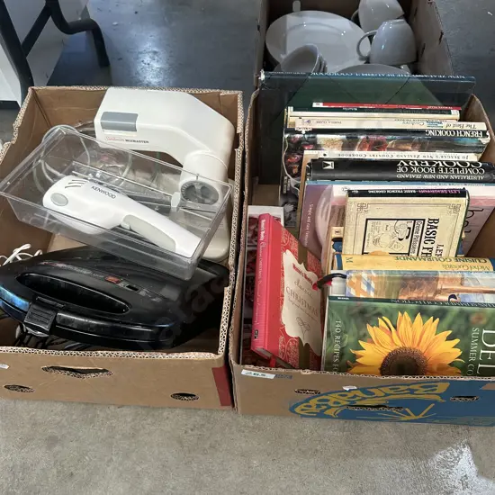 Two boxes mixer, electric knife and cookbooks.