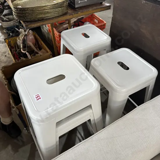 Four white bar stools