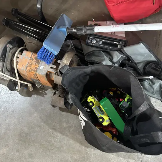 bench grinder, chair, toys, hose brush, stereo
