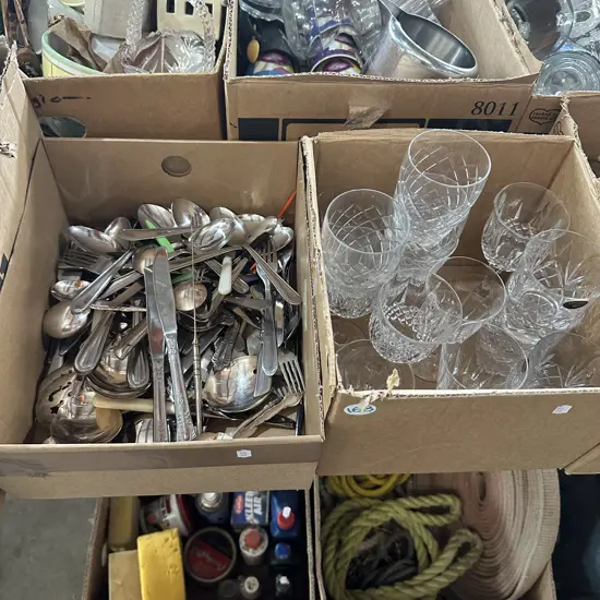Two boxes cutlery and crystal glasses.