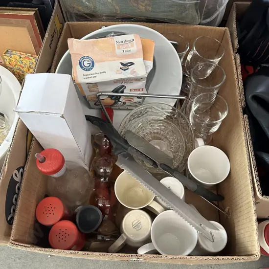Box of assorted cups, bowls, knives plus cushions etc.