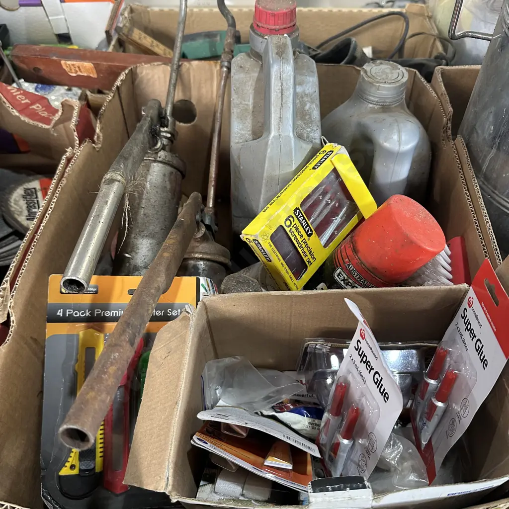 Box lot with grease guns, automatic transmission fluid, super glue and knife packs etc. Image 1++