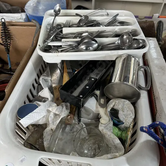 Basket full of kitchenware, knives, cutlery etc.