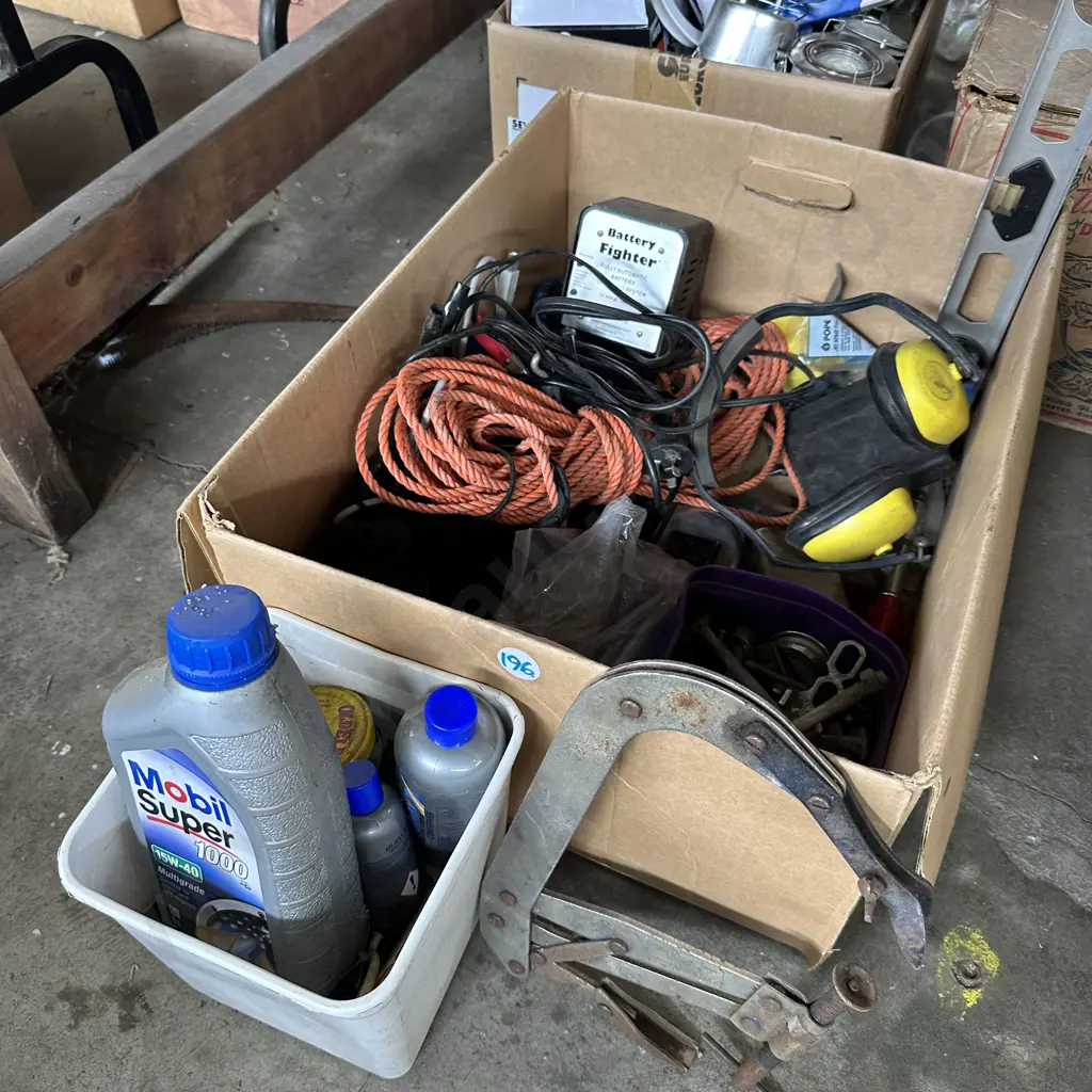 Box of hardware including "top up" oil and battery charger etc. Image 1++