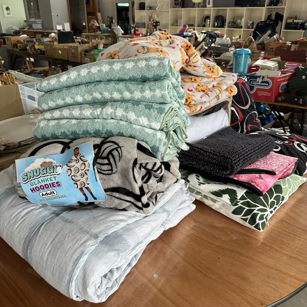 Large lot of bedding, onesie blanket hoodies, towels, and cushions. Image 1++