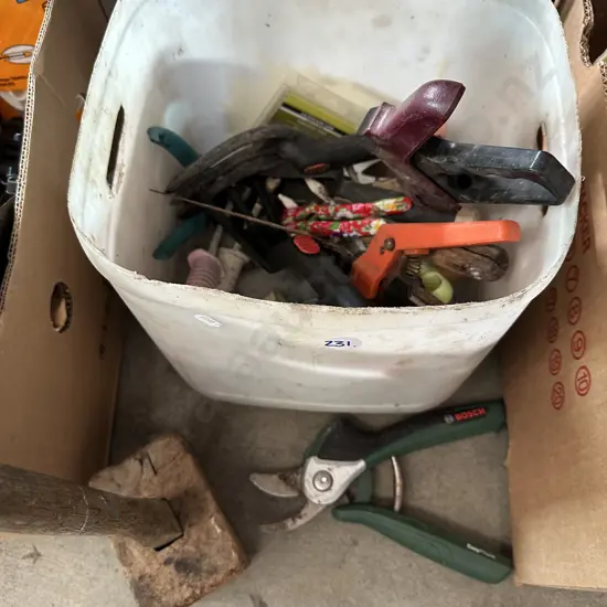 Bin of gardening tools and wooden mallet