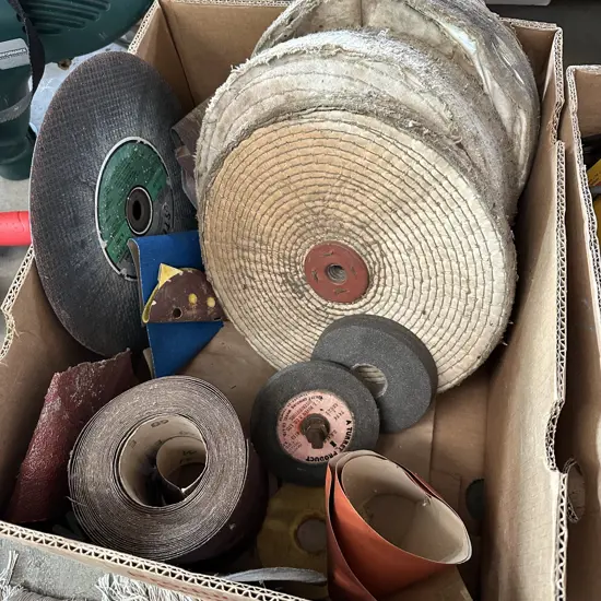 Bin of sandpaper, polishing and grinding disks etc.