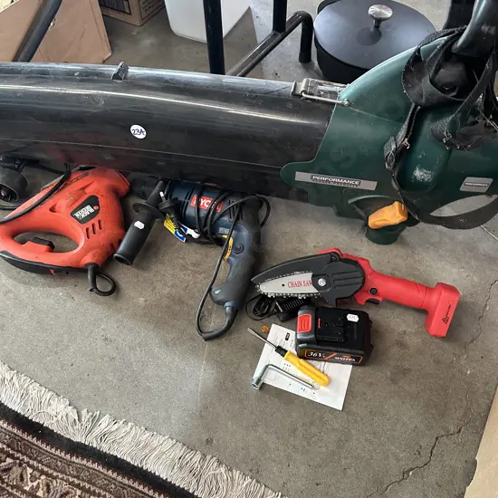 Blower/vac with no bag, power saw and drill. Battery chainsaw with fault.