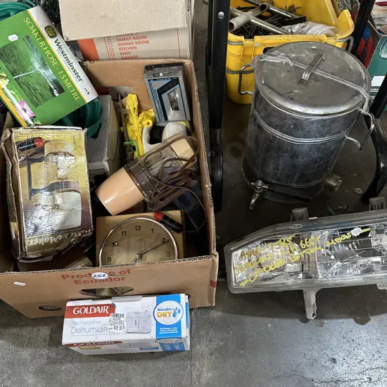 Box of assorted items including soaker hose and honda headlight etc.