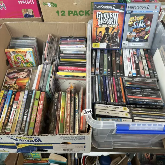 Lidded bin and box full of CDs and DVD movies, plus two playstation 2 games.