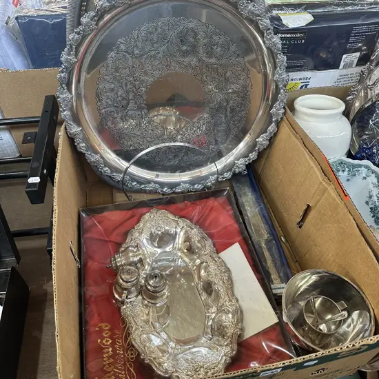 Box of silverware including large serving trays.