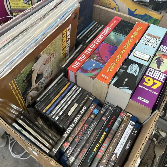 Box of movie books, LPs, CDs and DVDs.